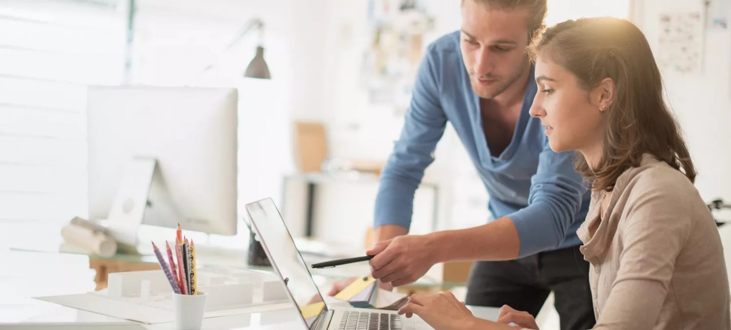 man and woman looking at laptop
